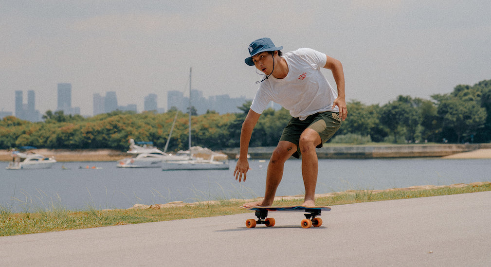 man surfskating by the sea