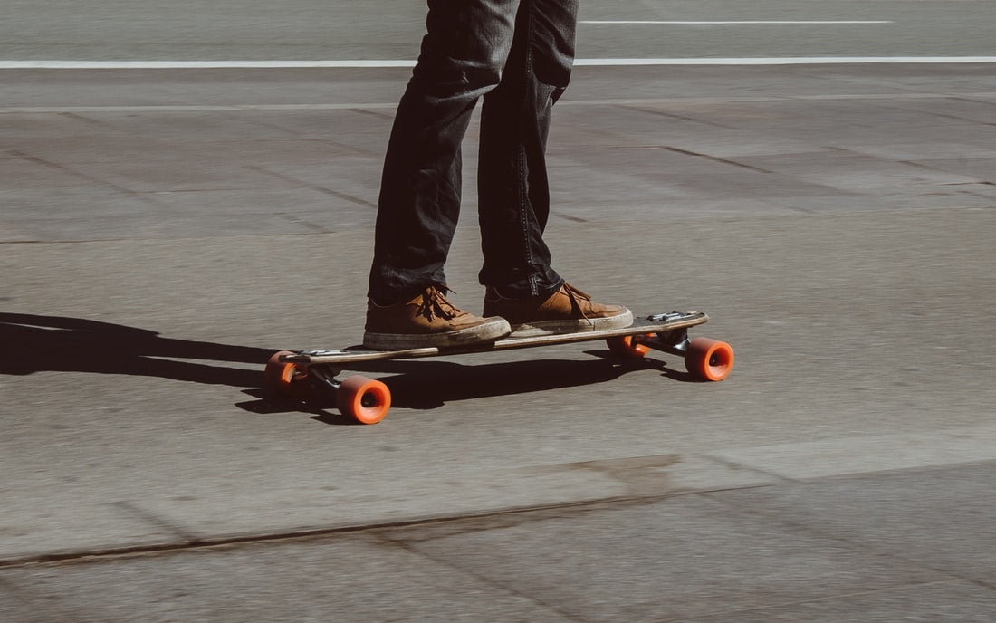 Man commuting on longboard