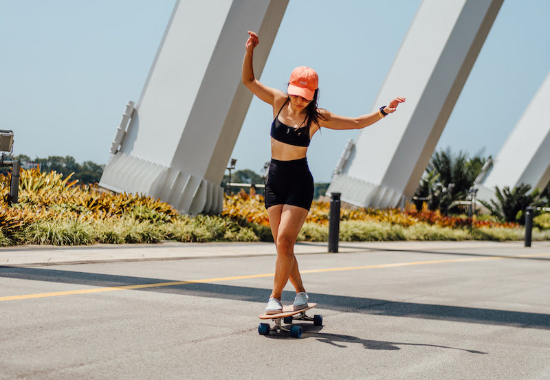 woman dancing on a surfskate longboard in the city
