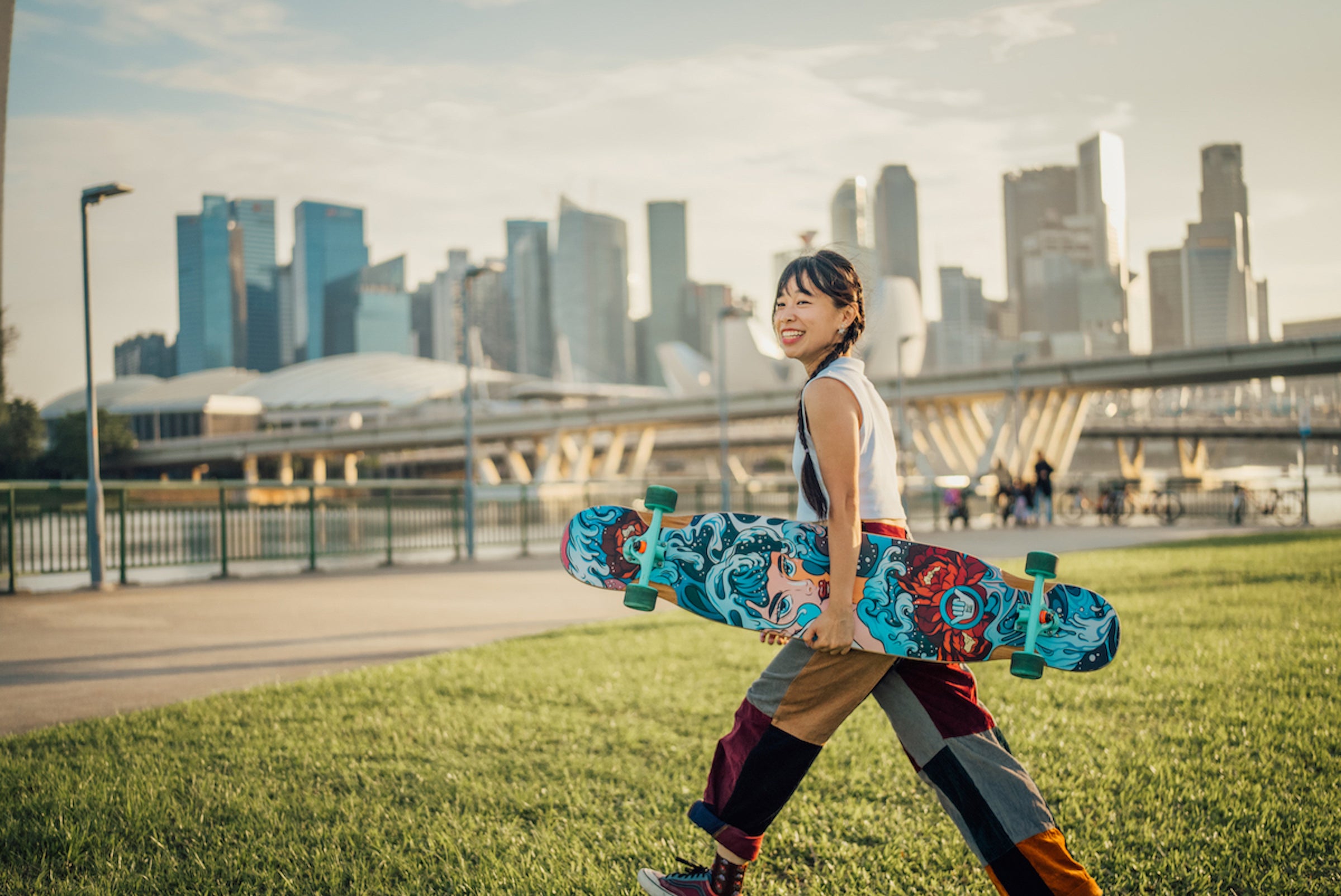 girl walking with longboard with wave design
