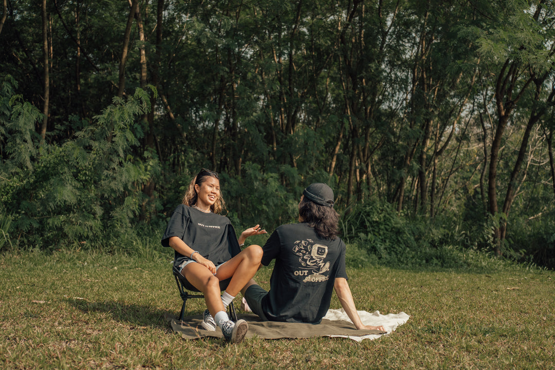 two friends in a relaxed black graphic t shirt outdoors
