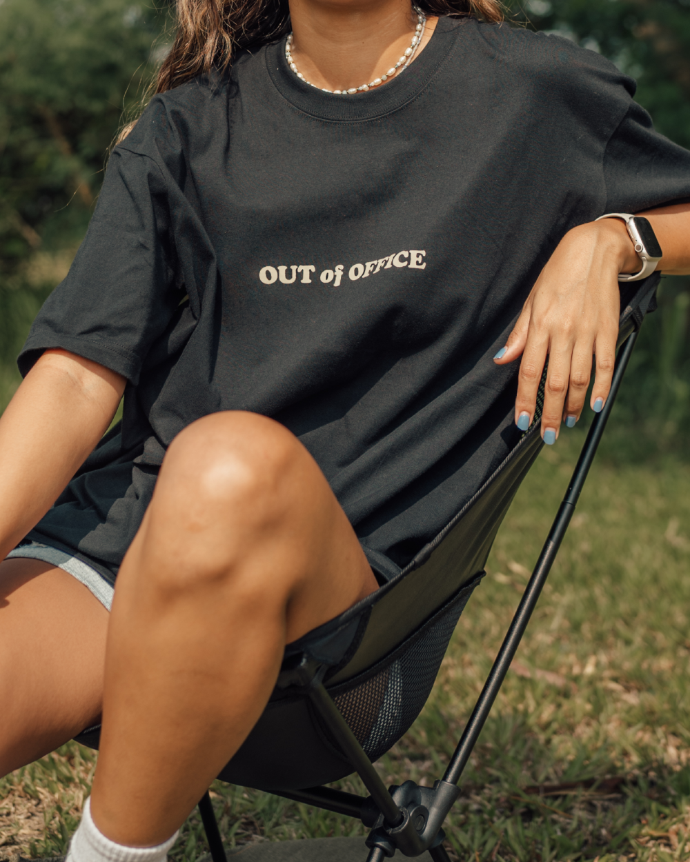woman relaxing on outdoor chair in a black t shirt
